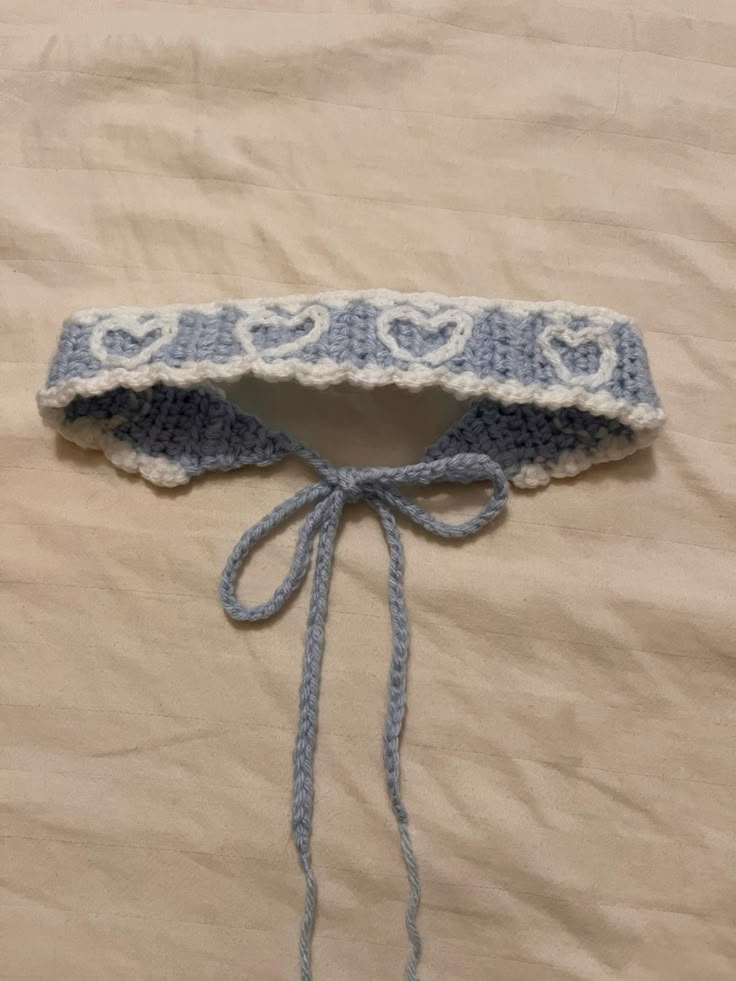 Knitted blue and white collar on a beige fabric background